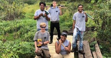 Volunteers pose on trail