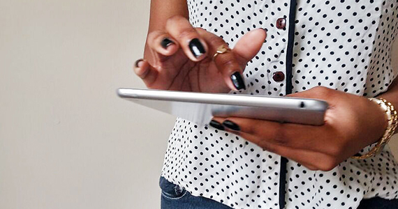 person looking at news on a tablet